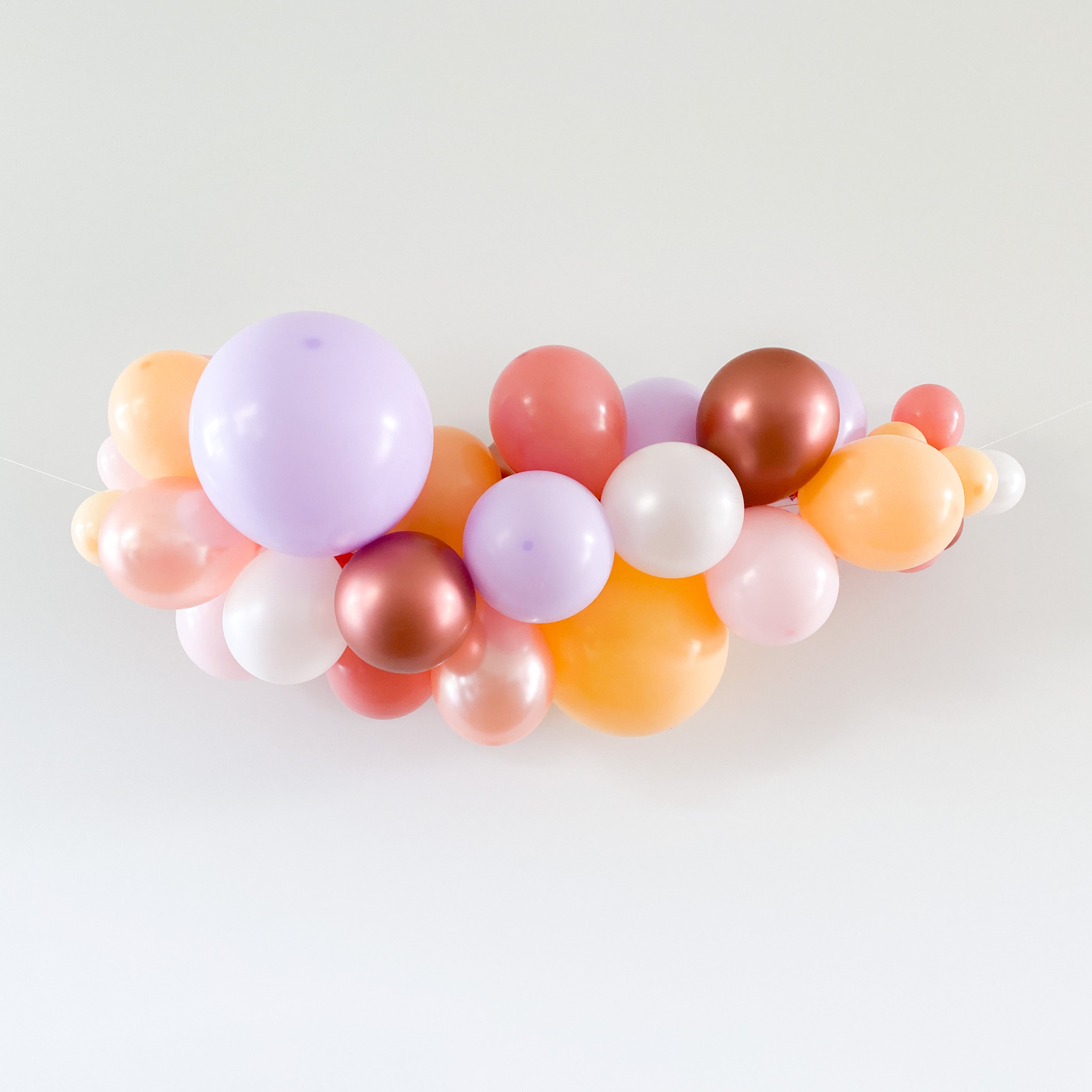 Ballonslinger ballonnenboog oranje blush roze paars wit brons pastel als feestdecoratie