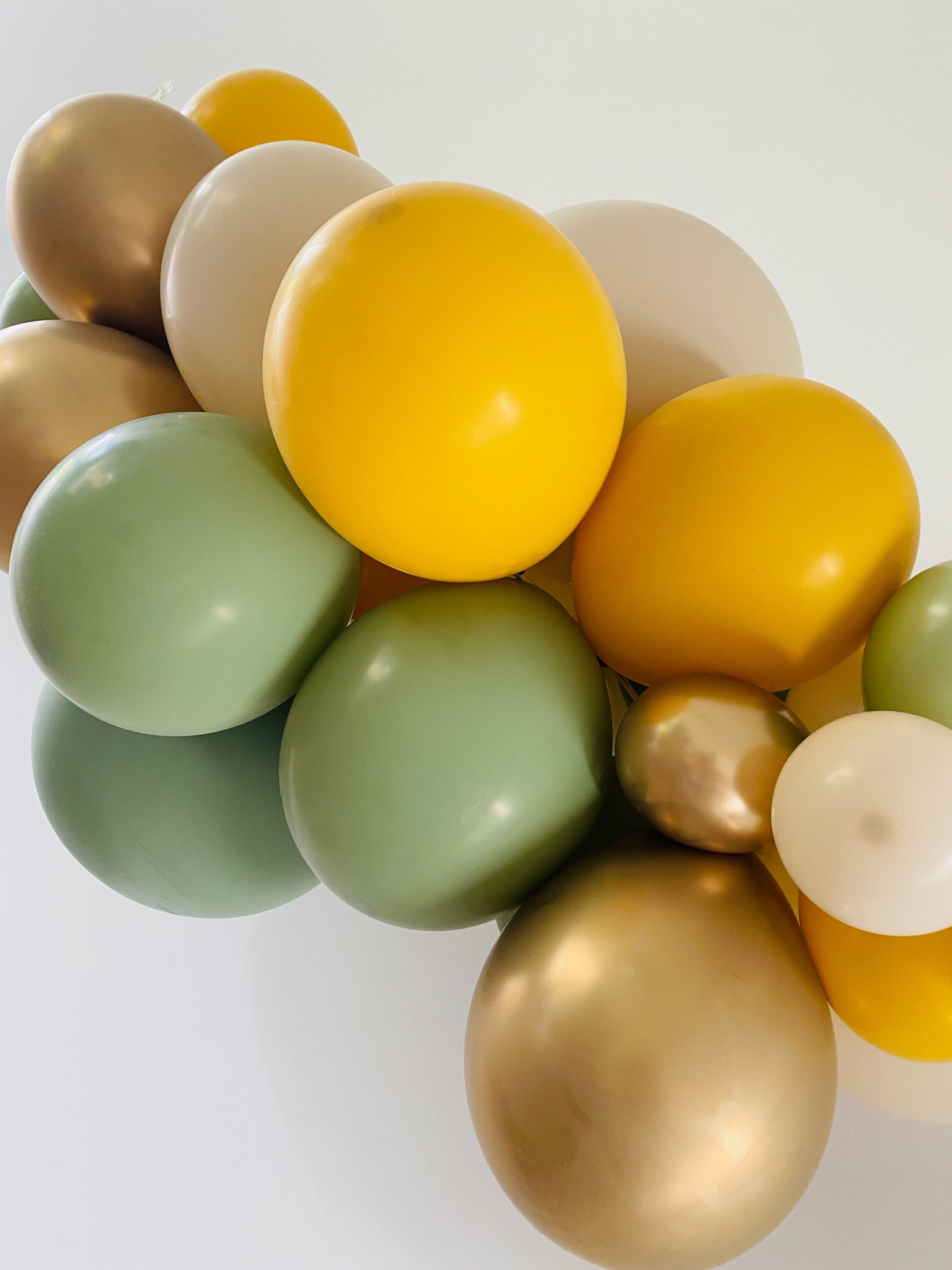 Ballonslinger ballonnenboog mosterd geel eucalyptus groen zand goud als feestdecoratie